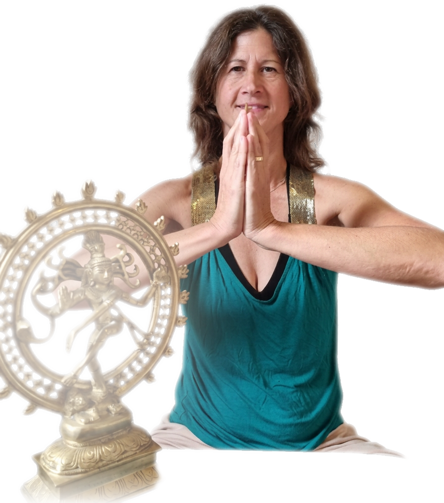Jessi in prayer pose beside a Nataraja statue